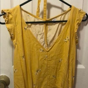 Yellow romper with white daisy’s on it